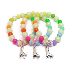 These adorable bracelets are the perfect addition to your little one's Skating party! Each bracelet features a Tibetan silver charm, resin rhinestone beads, an assortment of bright rainbow 10mm acrylic beads and 8mm glow in the dark beads strung with durable stretch floss cord. Stretch floss cord does not lose it's elasticity like the plastic type of stretch cord does so your little one and her friends will be proud to wear and show off their beautiful bracelets long after the party. Each bracel Glow In The Dark Beads, Skate Birthday, Skating Party, Skate Party, Cardboard Jewelry Boxes, Beautiful Bracelets, Girl Rainbow, Bright Rainbow, Birthday Supplies