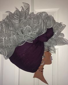 This Gorgeous Diva Wreath embodies everything we love about our heritage.   Measuring 26 inches by 26 inches this wreath can be displayed at the office on the wall,  door, or bathroom options are limitless.Diva wreath, made to order and custom made for you.  This Afrocentric door or wall decor is made from scratch with hand painted lips and eyes. Additionally lashes, earrings, necklace and scarf are added to this beautiful masterpiece to bring her to completion. THE DIVA WREATH PICTURED IS FOR DISPLAY PURPOSES ONLY! EACH DIVA IS UNIQUE, AND NO TWO ARE EXACTLY ALIKE. The Diva, Wall Door, Door Wreath Hanger, How To Make Wreaths, Door Hanger, Beauty Book, Diva, Etsy Accessories, Lashes