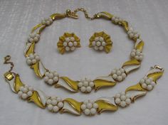 "To die for! This is an early pre-copyright symbol, three piece matching set from Crown Trifari, in excellent condition! The links are white and yellow enameled on gold tone metal, with clusters of white cabochons separating and defining the pieces. The necklace and bracelet are both a little over 1/2\" wide. The decorative part of the necklace with hook measures 13 & 1/4\", with gold extension links of an additional 2 & 3/4\", to make it an adjustable size choker. The hook has TRIFARI on it. The bracelet measures 7\" long and has a hinged fold over clasp with the Crown TRIFARI mark. There is a safety chain that measures 2 & 1/4\" with a spring ring. The earrings have the crown TRIFARI mark on the back of the clips and they measure 1\" from top to bottom and 3/4\" wide. There is nearly NO Necklace Matching, Trifari Jewelry, Crown Trifari, Matching Bracelet, Necklace And Bracelet, Matching Bracelets, Clip Earrings, Vintage Costume Jewelry, Link Necklace