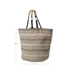 Are you looking for a stylish, eco-friendly bag that’s perfect for the beach or any weekend trip? Look no further than the Dobi Shoulder Tote – Black. This spacious, roomy tote, made of handwoven Jute-Cotton fabric, is stylish and durable enough to withstand however much you choose to carry. Featuring a unique round bottom shape and color accent on the handle, this bag transitions easily into any season. Plus, each product is sustainably handmade by Fair Trade artisans in Bangladesh.The Dobi Sho Modern Handwoven Straw Bag For Everyday Use, Eco-friendly Black Bucket Bag With Leather Handles, Modern Bucket Bag With Braided Handles For Beach, Modern Beach Bucket Bag, Modern Tote Beach Bag For Vacation, Modern Bucket Tote Bag For Vacation, Modern Handwoven Bags For Vacation, Modern Double Handle Straw Bag For Beach, Black Canvas Beach Shoulder Bag