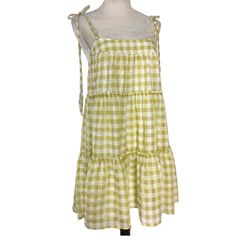 Get Ready To Turn Heads With This Stunning Altar'd State Gingham Tiered Mini Sundress, Perfect For Any Occasion! Featuring A Square Neckline With Strappy Sleeves And A Tie Closure, This Colorful Dress Is Made Of High-Quality Polyester Fabric And Is Fully Lined. The Layered Accents And Short Dress Length Add A Touch Of Boho Vibes, Making It A Great Choice For Summer, Fall, And Spring. This Dress Is Sized As Small And Is Crafted For Women Who Love To Express Their Unique Style. Don't Miss Out On T Picnic Gingham Sundress With Ruffles, Green Cotton Mini Dress For Picnic, Summer Gingham Dress With Ruffle Hem, Gingham Cotton Mini Dress For Beach, Gingham Cotton Mini Dress For The Beach, Beach Gingham Dress With Ruffle Hem, Gingham Beach Dress With Ruffle Hem, Gingham Dress With Ruffle Hem For Beach, Gingham Dress With Ruffle Hem For Vacation