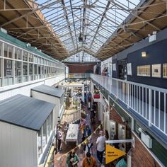 an indoor market with people walking around