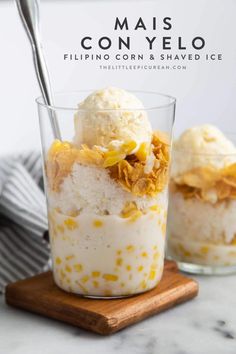 two glasses filled with ice cream on top of a wooden board next to a spoon