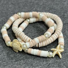 three bracelets with shells and starfish charms