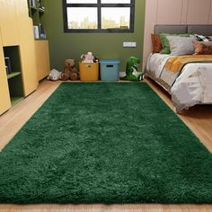 a bedroom with green carpet and wooden flooring on the floor, next to a bed