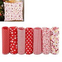 christmas presents are lined up in front of a tree and decorated with red and white polka dots