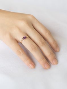 A unique spin on a modern classic. The Lady's Mantle Amethyst ring stuns with an amethyst center stone of a rich purple. It's a great present for those born in the month of love, February. 14k Gold Purple Emerald Cut Rings, Purple 14k Gold Ring With Emerald Cut, Purple 14k Gold Rings With Emerald Cut, Modern Purple 14k Gold Jewelry, Purple Birthstone Ring With Center Stone In 14k Gold, Modern Purple Amethyst Ring With Accent Stones, Modern 14k Gold Amethyst Wedding Ring, Purple Ruby Ring In 14k Gold, 14k Gold Lavender Amethyst Ring