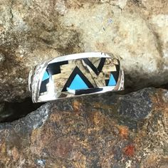 This beautiful Sterling Silver Ring, as part of the Turquoise Creek Collection, features Black Jade, Picture Jasper, and Kingman Turquoise. The ring is designed by David Rosales, one of the finest contemporary Southwest Artists in the world. He is the founder and co-owner of Supersmiths, Inc. of Gallup, NM. Each ring is custom made and carries a lifetime guarantee. Contemporary Southwest, Arrow Jewelry, Black Jade, Black Arrow, American Indian Jewelry, Southwest Jewelry, Kingman Turquoise, Picture Jasper, Infiniti Logo