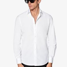 Discover effortless elegance with this crisp white shirt, boasting a flattering tailored silhouette and meticulous details like heat-sealed buttons and an offset armhole seam for a sharp look. White Shirt With Button Cuffs And Lapel Collar, White Office Dress Shirt With Placket, White Dress Shirt With Placket For Office, White Business Tops With Fold Down Collar, White Business Casual Shirt With Placket, White Shirt With Placket For Business Casual, White Business Top With Fold Down Collar, White Shirt With Placket For Work, Timeless White Shirt With Placket