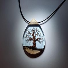 "A handmade tree of life necklace made from copper, olive wood and resin. This unique statement necklace is a real conversation starter. A unique take on wire wrapping, this pendant will make you stand out from the rest! The wood has been stabilized for added protection and the piece is polished to a high gloss finish, making the resin necklace completely smooth to the touch and mirror like. D E T A I L S - Large pendant - approximately 65mm x 40mm (2.5 inches x 1.5 inches) - Made from copper wi Resin Crafting, Real Conversation, Unique Statement Necklace, Handmade Tree, Mountain Necklace, Resin Pendant Necklace, Necklace Wood, Carving Patterns, Wood Carving Patterns