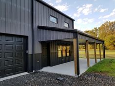 a large metal building with two garages on each side and one door open to let in light