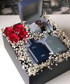 an open box with flowers and two cell phones in it