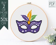 a cross stitch mask with flowers in the background and text that reads buy 2 or more get 50 % off