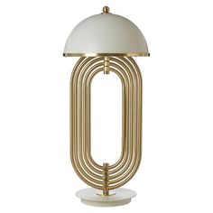 the brass and white lamp is on top of a stand with an oval light fixture