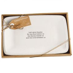 a happy thanksgiving message on a white plate in a box with twine and string