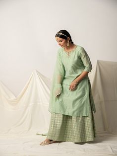 Green silk chanderi kurta with sequins work on neck, has a three-quarter sleeves, keyhole neckline. Green brocade skirt, this kurta skirt comes with doriya dupatta highlighted with sequins work and tassels Fabric: Top - Chanderi Silk Bottom - Brocade Silk Dupatta - Kota Doria Color: Green Note: Available in other colors Bottom not included with the product. Bottom can be bought separately Wash Care Instruction - Dry Clean Only The product will be shipped within 15-20 days of order placed Size Ch Cotton Silk Lehenga With Straight Kurta For Eid, Cotton Silk Straight Kurta With Gota Work, Slub Silk Straight Kurta Dress For Eid, Straight Kurta Slub Silk Dress For Eid, Festive Slub Silk Straight Kurta Dress, Kurta Skirt, Silk Kurta Set, Brocade Skirt, Silk Bottoms