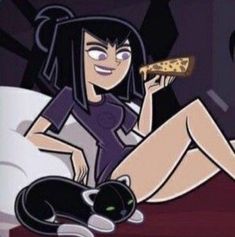 a woman sitting on a bed with a slice of pizza in her hand and a cat laying next to her