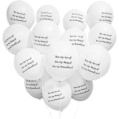 a bunch of white balloons with writing on them