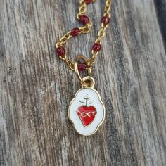 "Sacred Heart Gold Pendant Charm. Beautiful and super cute pendant-charm made in 18k gold, not plated, not filled. This piece is solid, not hollow. Use it in a necklace with lots of charms, alone or in a bracelet. This is truly a piece you can pass down to your younger generations as a keepsake. SIZE Tall: 0.72\" / 18.4mm (aprox. including bail) Wide: 0.34\" / 8.8mm (in the widest part) Come follow us on Instagram as @orommajewelry and @shinyhappylily to see many more amazing pieces and to get d Heart Pendant Charms With Lobster Clasp, Gold Plated Charms With Lobster Clasp As Gift, Gold Plated Charms With Lobster Clasp For Gift, 14k Gold Pendant Charm Necklace For Valentine's Day, Valentine's Day Gold-plated Jewelry With Dangling Charms, Dainty Charms With Lobster Clasp For Gifts, Gold Plated Heart Charm Pendant, Gold Plated Pendant Charms As Gift, Handmade Yellow Gold Pendant Charms