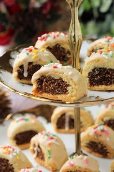 there is a cake roll on a plate with frosting and sprinkles