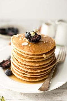 a stack of pancakes with blueberries on top