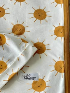 an orange and white blanket with yellow sun print