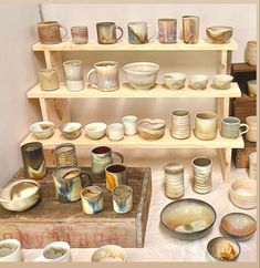 many different bowls and plates are on display