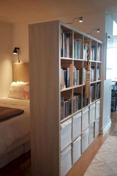 a room with a bed and a book shelf