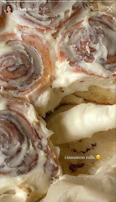 cinnamon rolls with icing sitting on top of each other