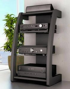 there is a shelf that has several different types of audio equipment on top of it