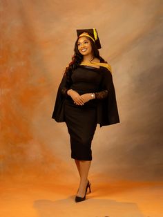 a woman in a graduation cap and gown posing for the camera with her hands on her hips