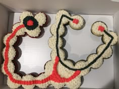 cupcakes in a box decorated with red, white and black icing