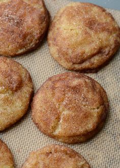 some sugary cookies are sitting on a piece of wax paper