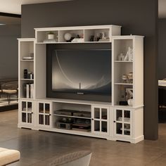 This wall unit features a 68 inch console, two pier units and an overhead bridge providing ample storage options. This media unit features black finished knobs, glass doors with wood framing, open storage, and adjustable shelves. The console will accommodate most 75 inch TV. FUFU&GAGA Modern/Contemporary White Tv Cabinet (Accommodates TVs up to 65-in) | KF020341-01 +02 White Tv Cabinet, Bookshelves With Tv, Wall Unit Designs, Bookcase Tv Stand, Large Tv Stands, Floating Bookshelf, Modern Entertainment Center, Wooden Tv Stands, White Tv