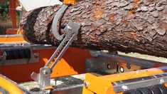 a large log is being loaded onto a trailer