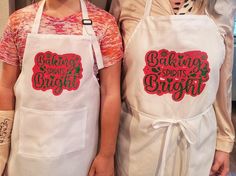 two women in aprons standing next to each other