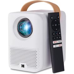 an image of a projector with a remote control next to it on a white surface