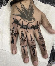 a hand with barbed wire and birds on it