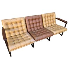 three leather couches sitting next to each other