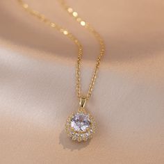 Material: Titanium Steel Fashion Element: Petals Style: Affordable luxury style Elegant Rhinestone Clavicle Chain Necklace With Round Pendant, Elegant Rhinestone Necklace With Round Pendant, Rhinestone Necklace With Round Pendant For Party, Elegant Gold Rhinestone Necklace With Round Pendant, Party Rhinestone Necklace With Round Pendant, Gold Rhinestone Round Pendant Necklace, Elegant Rhinestone Clavicle Chain Necklace, Gold Rhinestone Clavicle Necklace, Cubic Zirconia Round Pendant Necklace For Parties