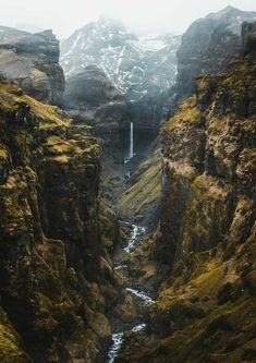 there is a small waterfall in the mountains