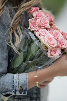 black and white photograph of a woman holding roses in her hands with the words i love you written on it