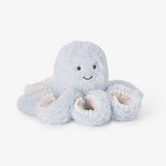 an octopus stuffed animal sitting on top of a white floor