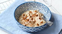 a blue and white bowl filled with oatmeal on top of a blue napkin