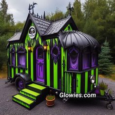 a green and black house with purple trim