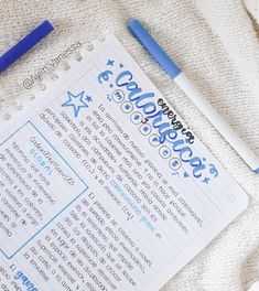 a blue pen sitting on top of a paper next to a white sheet with writing