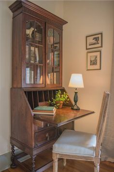 a wooden desk with a book shelf and chair