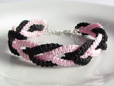 a pink and black bracelet on a white plate