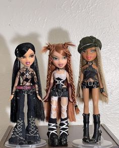 three dolls are standing next to each other