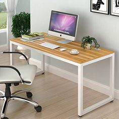 a desk with a computer and chair in front of it